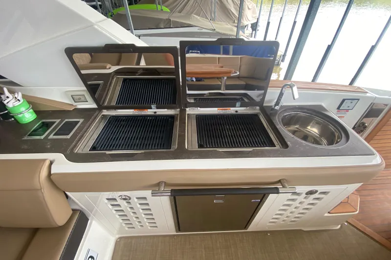Slide: The Image of Outdoor kitchen on 2019 Sea Ray SLX 400 boat with grill and sink. - 59