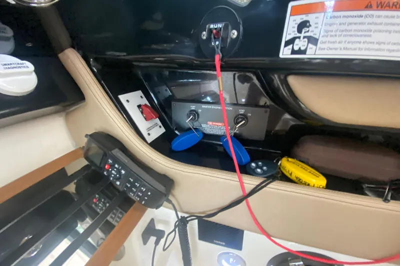 Slide: The Image of Control panel of a 2019 Sea Ray SLX 400 boat with switches and warning labels. - 30