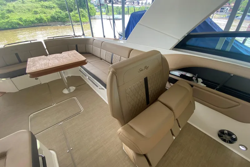 Slide: The Image of Interior of 2019 Sea Ray SLX 400 boat with beige seating and wooden table. - 23