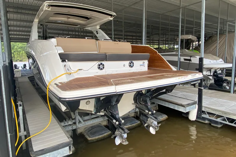 Slide: The Image of 2019 Sea Ray SLX 400 boat docked in a covered marina. - 2
