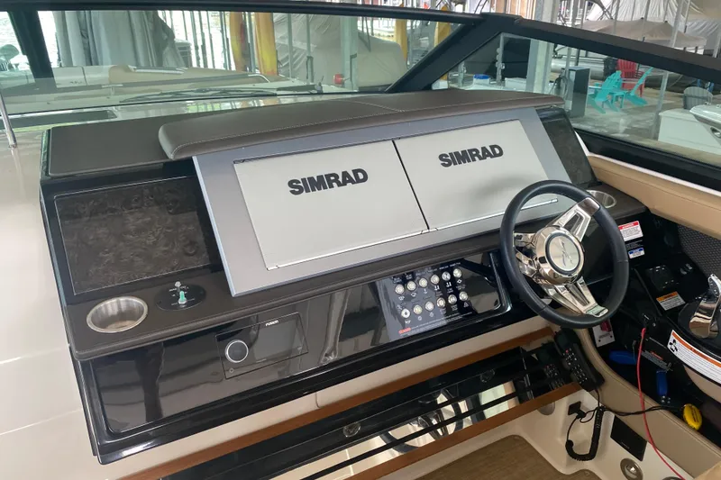 Slide: The Image of 2019 Sea Ray SLX 400 helm with Simrad displays and modern steering wheel. - 47