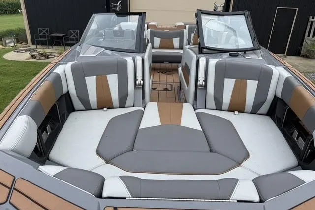 Slide: The Image of 2022 Malibu Wakesetter 23 MXZ interior with stylish gray and brown seating. - 7
