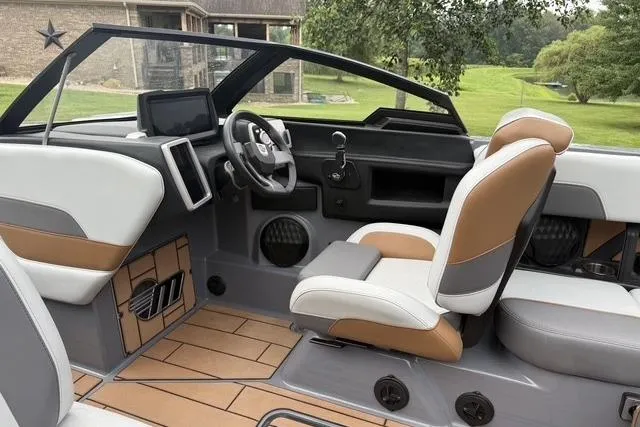 Slide: The Image of 2022 Malibu Wakesetter 23 MXZ boat interior with modern dashboard and comfortable seating. - 10