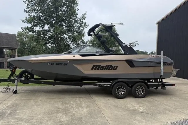 The Image of 2022 Malibu Wakesetter 23 MXZ boat on trailer, parked outdoors. - 0
