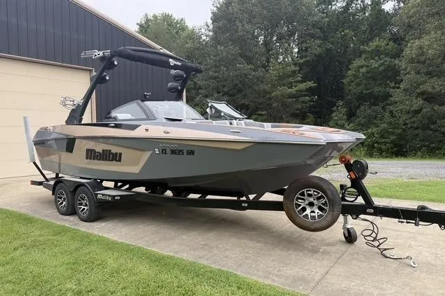 Slide: The Image of 2022 Malibu Wakesetter 23 MXZ boat on trailer, parked outdoors near a building. - 5
