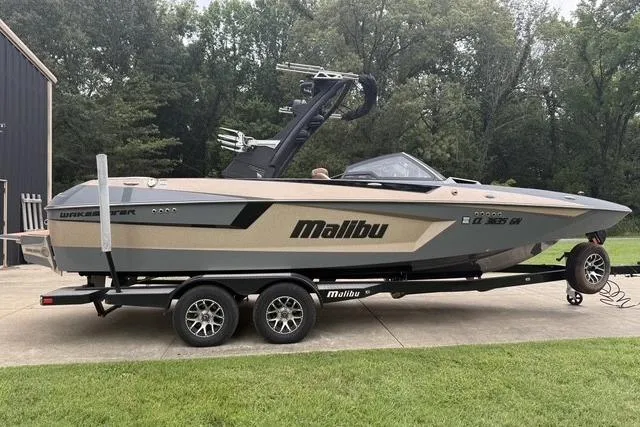 Slide: The Image of 2022 Malibu Wakesetter 23 MXZ boat on trailer, parked outdoors. - 4