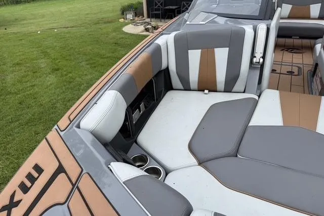 Slide: The Image of 2022 Malibu Wakesetter 23 MXZ boat interior with stylish seating and cup holders. - 9