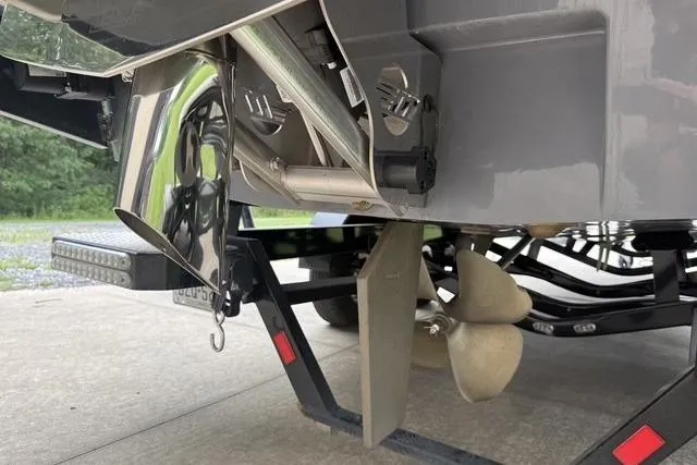 Slide: The Image of 2022 Malibu Wakesetter 23 MXZ boat propeller and rudder detail on trailer. - 19