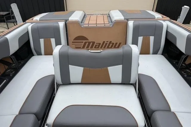 Slide: The Image of 2022 Malibu Wakesetter 23 MXZ boat interior with stylish seating and logo. - 22