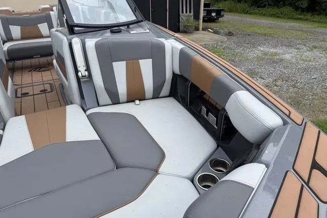 Slide: The Image of 2022 Malibu Wakesetter 23 MXZ interior with gray and brown seating, cup holders, and sleek design. - 8