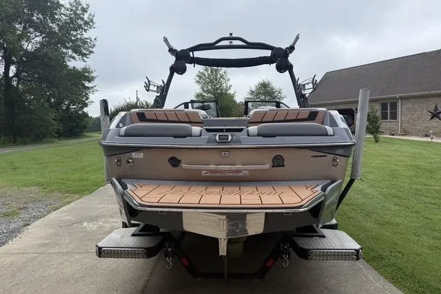 Slide: The Image of 2022 Malibu Wakesetter 23 MXZ boat, rear view, parked on driveway. - 2
