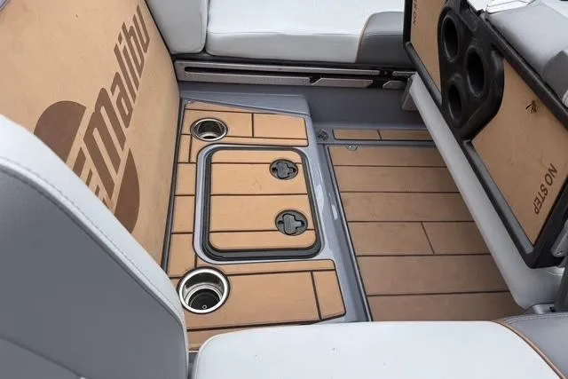 Slide: The Image of 2022 Malibu Wakesetter 23 MXZ interior with teak flooring and cup holders. - 15