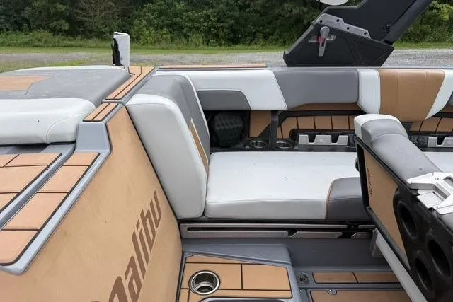 Slide: The Image of 2022 Malibu Wakesetter 23 MXZ interior with tan and gray seating. - 14