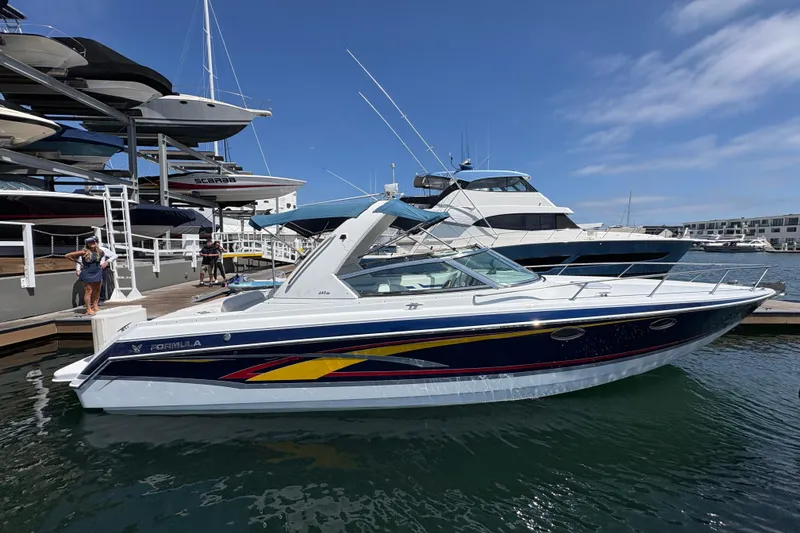 The Image of 2007 Formula 330 Sun Sport boat docked at marina under clear blue sky. - 0