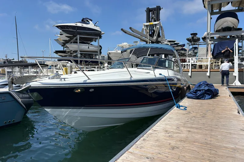 Slide: The Image of 2007 Formula 330 Sun Sport boat docked at marina, clear sky background. - 5