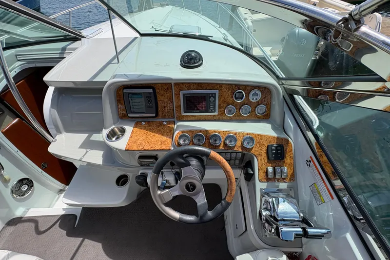 Slide: The Image of Cockpit of 2007 Formula 330 Sun Sport boat with wood-accented dashboard and steering wheel. - 13