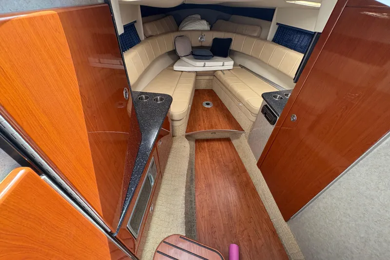 Slide: The Image of Interior of 2007 Formula 330 Sun Sport boat with wood finish and seating area. - 15