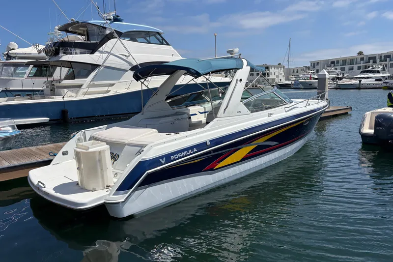 Slide: The Image of 2007 Formula 330 Sun Sport boat docked in marina, featuring sleek design and vibrant graphics. - 3