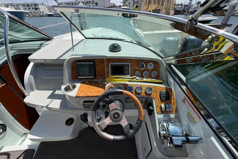 Slide: The Image of 2007 Formula 330 Sun Sport boat dashboard with steering wheel and control panel. - 12