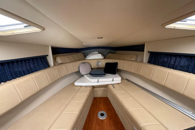 Slide: The Image of Interior of 2007 Formula 330 Sun Sport boat with beige seating and wooden flooring. - 16