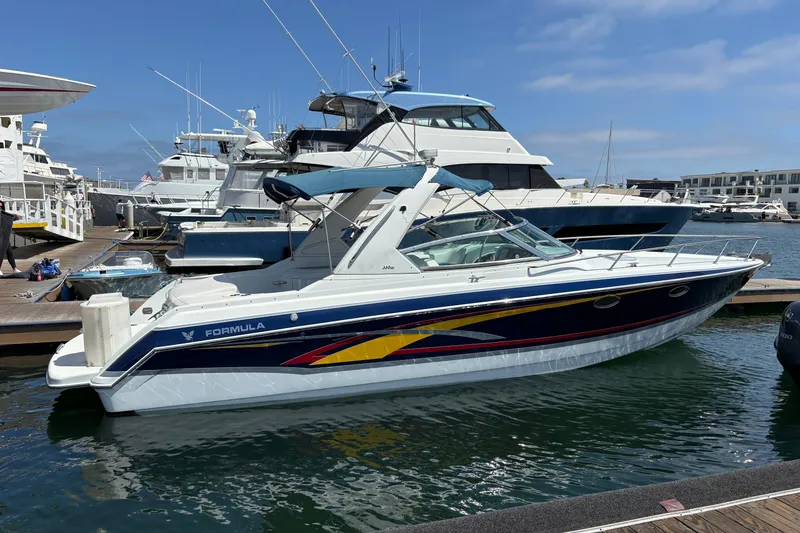 Slide: The Image of 2007 Formula 330 Sun Sport boat docked at a marina under a clear blue sky. - 2