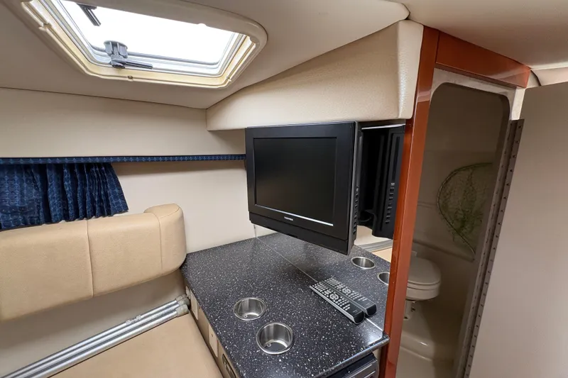 Slide: The Image of Interior of 2007 Formula 330 Sun Sport boat with TV, seating, and compact bathroom. - 21