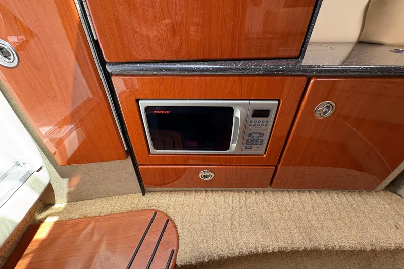 Slide: The Image of 2007 Formula 330 Sun Sport interior with microwave and wooden cabinetry. - 19