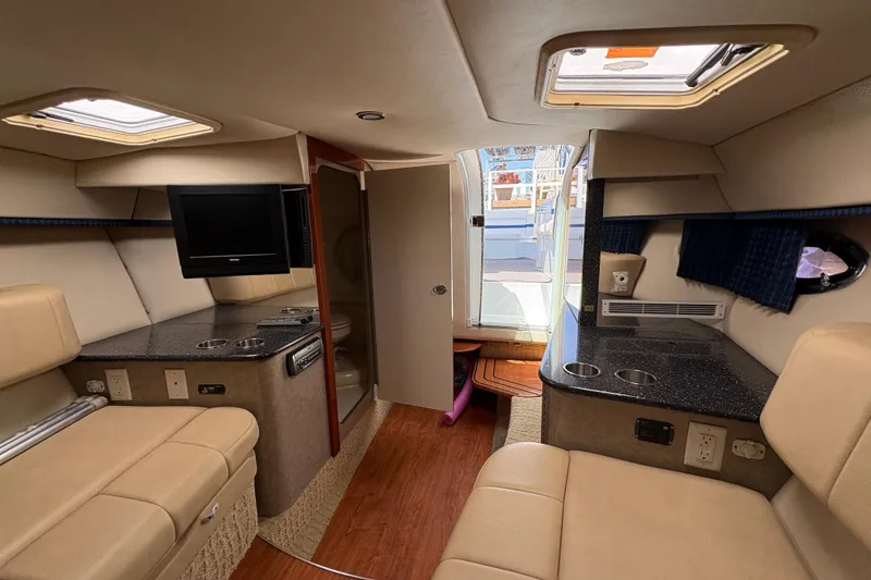 Slide: The Image of Interior of 2007 Formula 330 Sun Sport boat with seating, TV, and kitchenette. - 17