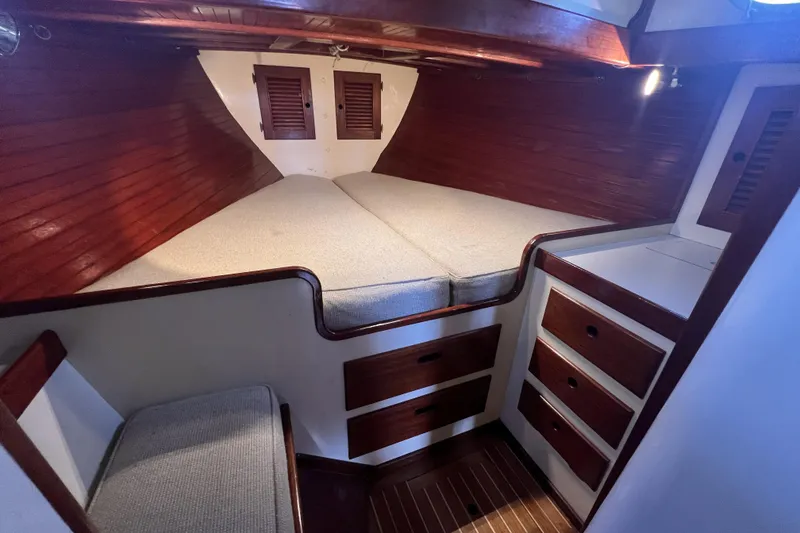 Slide: The Image of Cozy cabin interior of 1977 Alajuela 38 MKI sailboat with wooden finish and storage drawers. - 48