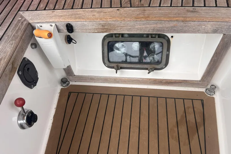Slide: The Image of Cockpit of 1977 Alajuela 38 MKI sailboat with wooden flooring and control panel. - 13
