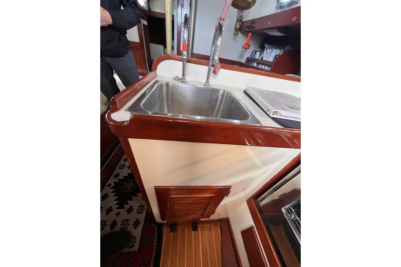 Slide: The Image of Interior of 1977 Alajuela 38 MKI sailboat featuring a compact kitchen sink area. - 39