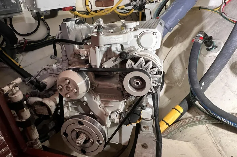 Slide: The Image of Engine compartment of a 1977 Alajuela 38 MKI sailboat, showcasing mechanical components and wiring. - 64