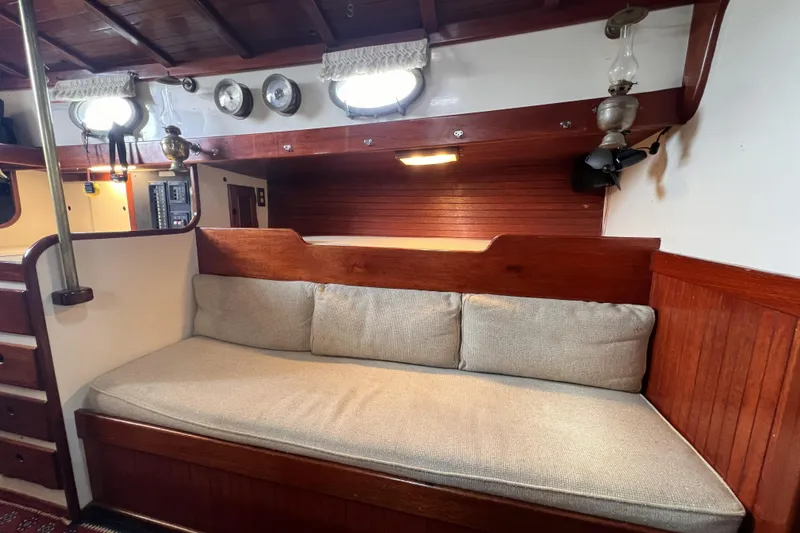Slide: The Image of Interior of 1977 Alajuela 38 MKI sailboat with wooden paneling and cushioned seating. - 46