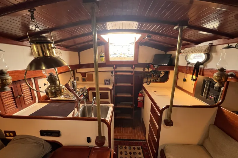 Slide: The Image of Interior of a 1977 Alajuela 38 MKI sailboat with wooden finishes and nautical decor. - 33