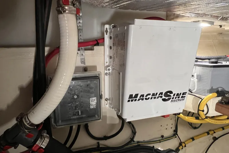 Slide: The Image of Electrical system inside a 1977 Alajuela 38 MKI boat featuring a MagnaSine inverter. - 63