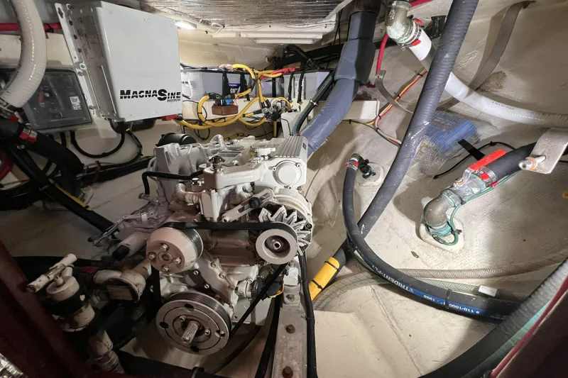 Slide: The Image of Engine room of a 1977 Alajuela 38 MKI sailboat with visible machinery and wiring. - 62