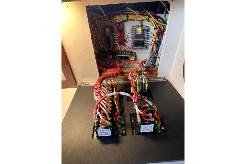 Slide: The Image of Electrical wiring setup inside a 1977 Alajuela 38 MKI boat, showcasing organized cables and components. - 59