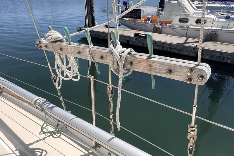 Slide: The Image of Rope and cleats on a 1977 Alajuela 38 MKI sailboat docked at a marina. - 28