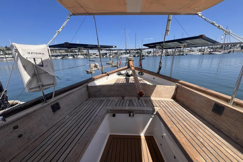 Slide: The Image of 1977 Alajuela 38 MKI sailboat deck with wooden finish, docked in a marina. - 14
