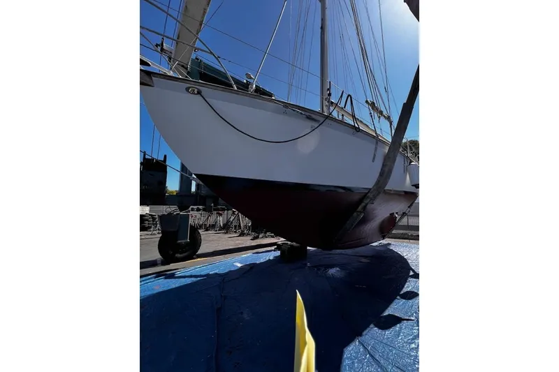 Slide: The Image of Sailboat Alajuela 38 MKI 1977 on dry dock, showcasing hull and rigging. - 67
