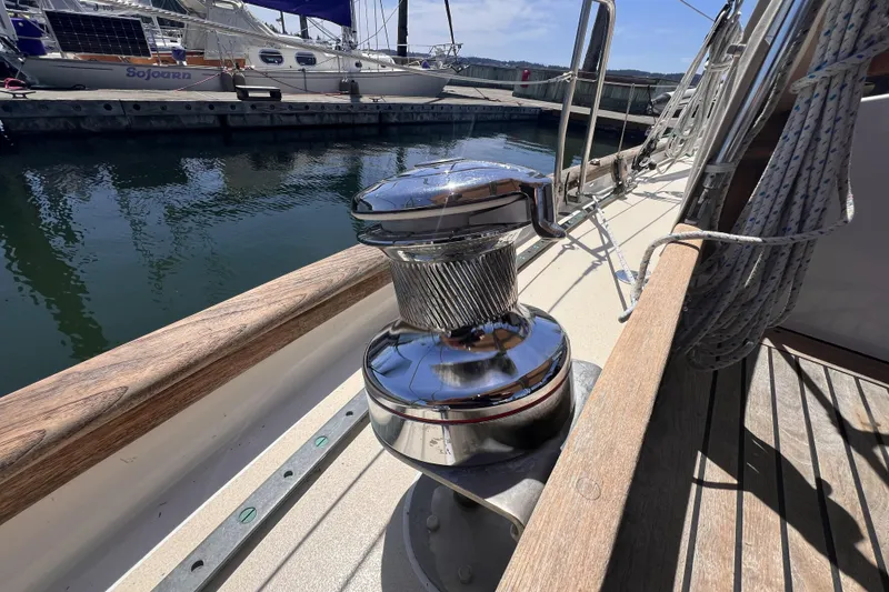 Slide: The Image of Chrome winch on 1977 Alajuela 38 MKI sailboat deck, docked at marina. - 16