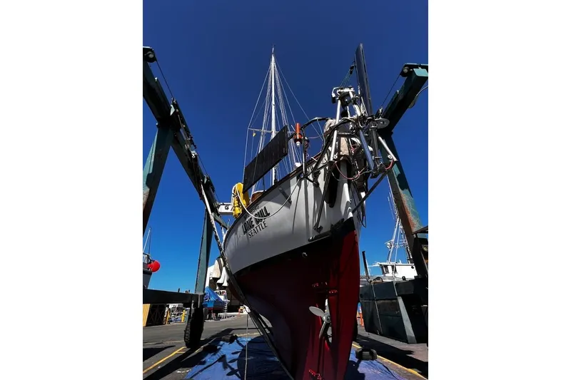 Slide: The Image of 1977 Alajuela 38 MKI sailboat in dry dock, Seattle, under clear blue sky. - 71