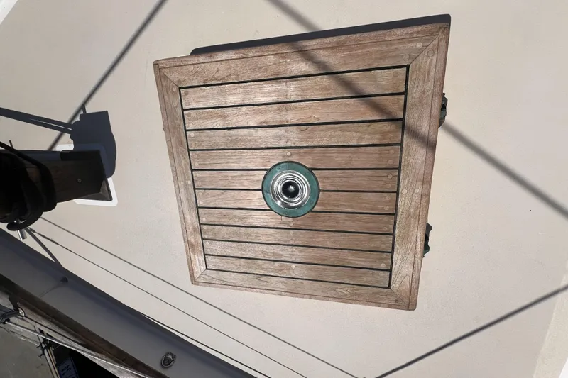 Slide: The Image of Wooden deck hatch on 1977 Alajuela 38 MKI sailboat, featuring a central metal fitting. - 21