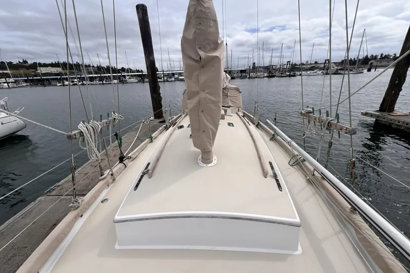 Slide: The Image of 1977 Alajuela 38 MKI sailboat deck view at marina, overcast sky. - 22