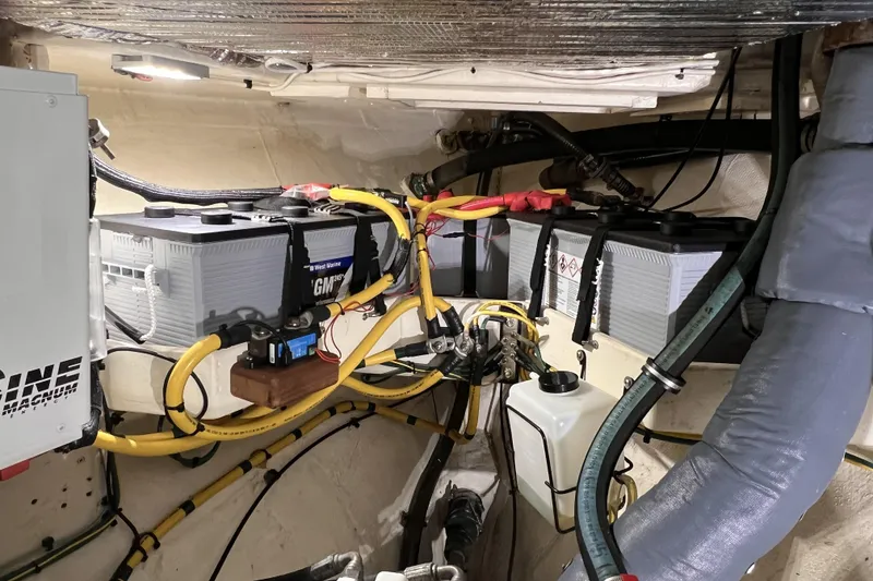 Slide: The Image of Engine room of a 1977 Alajuela 38 MKI with marine batteries and wiring. - 61