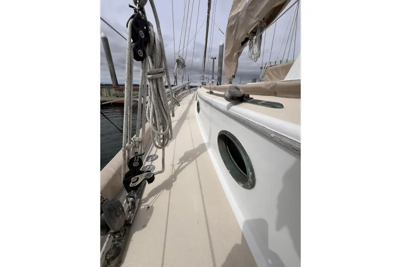 Slide: The Image of 1977 Alajuela 38 MKI sailboat deck with rigging and porthole, overcast sky. - 23