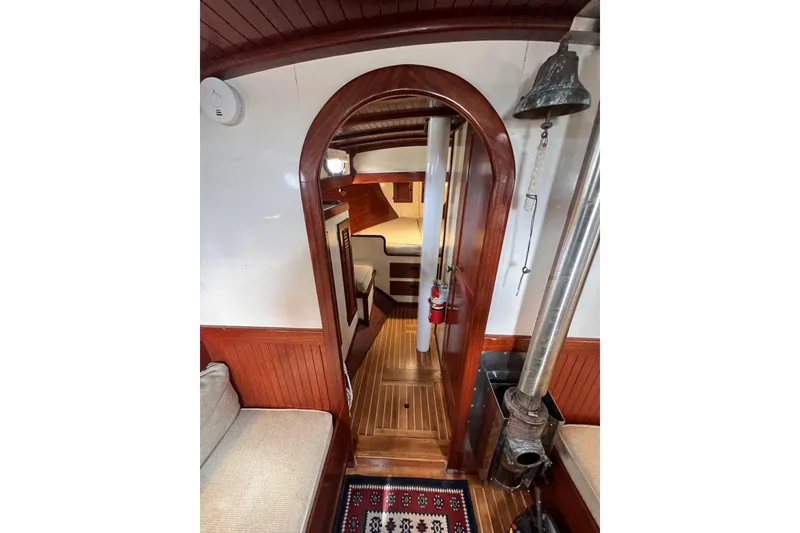 Slide: The Image of Interior of 1977 Alajuela 38 MKI sailboat with wood paneling and cozy seating area. - 47