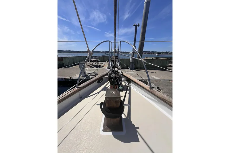 Slide: The Image of Bow view of 1977 Alajuela 38 MKI sailboat docked under clear blue sky. - 57