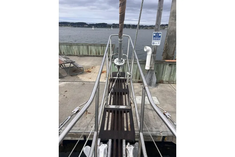 Slide: The Image of Sailboat docked at marina, Alajuela 38 MKI, 1977, with wooden deck and metal railings. - 29