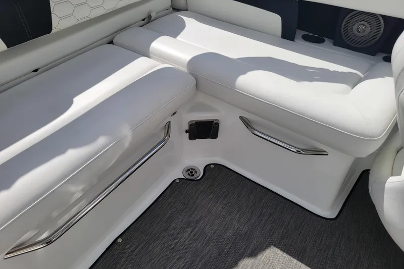 Slide: The Image of 2022 Four Winns HD3 boat interior with white cushioned seating and stainless steel accents. - 16